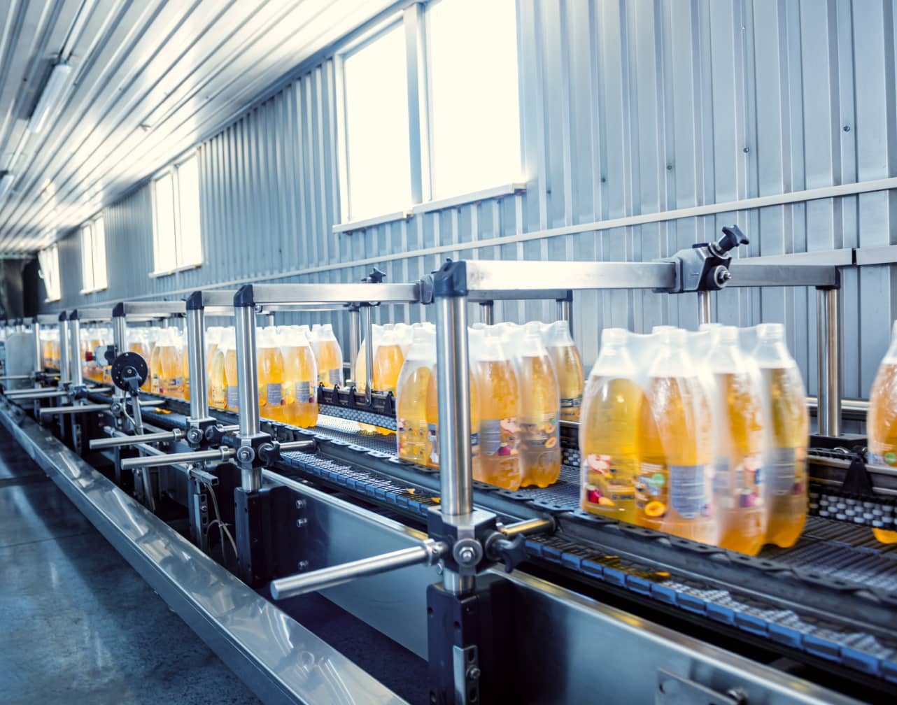 Packages of bottles moving down a conveyor